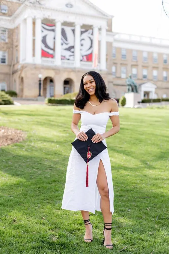 an off the shoulder white midi dress with a thigh high slit, black lace up shoes, a necklace and a cap are amazing for graduation