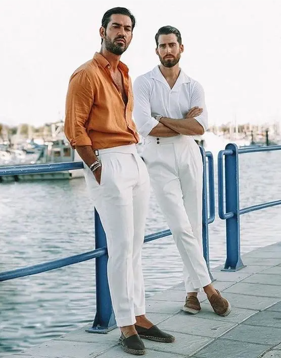 cool beach wedding guest looks with white trousers, a white and a marigold shirt, espadrilles