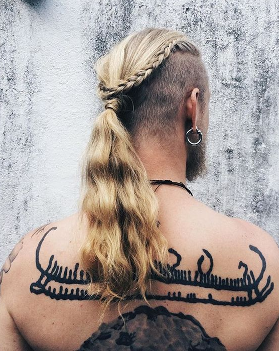 long hair with shaved sides, a braid and a long ponytail for a wild look is a cool hairstyle for a daring look