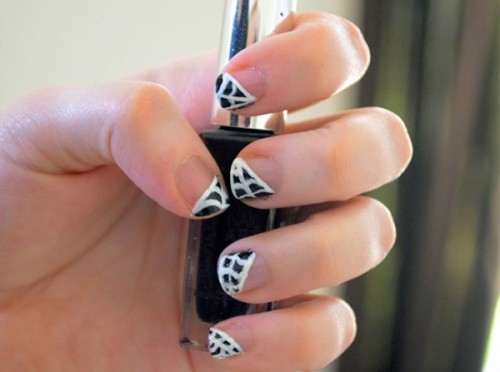 nude nails paired with black and white spiderweb is a stylish idea in a monochromatic color scheme