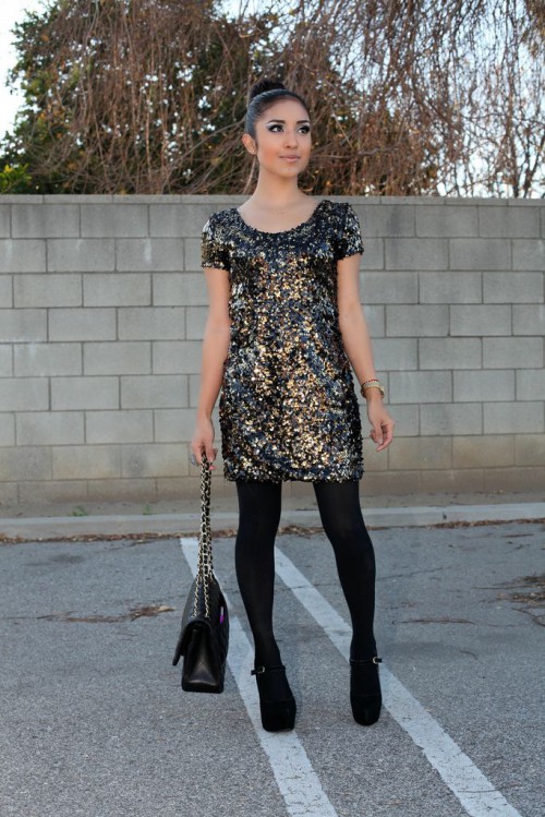 a black sequin mini dress with short sleeves, black tights, black shoes and a black bag for a chic all-black NYE look