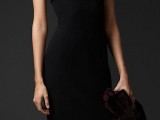 a black fitting midi dress with gold accessory on the neckline is a lovely idea for a NYE party