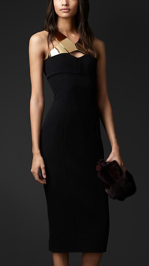 a black fitting midi dress with gold accessory on the neckline is a lovely idea for a NYE party