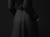 a classic black midi fitting trench with a bow on the back is a stylish piece to wear in any spring or fall