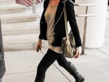 a long grey top, black skinnies, black tall boots, a black embellished blazer and a grey bag