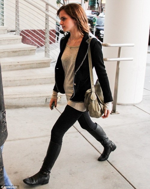 a long grey top, black skinnies, black tall boots, a black embellished blazer and a grey bag