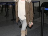 a white oversized sweater, grey skinnies, tan tall boots, a brown parka with faux fur for a cold winter