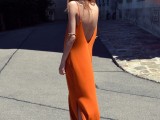 an orange slip maxi dress with an open back with side slits looks chic, bold and cool