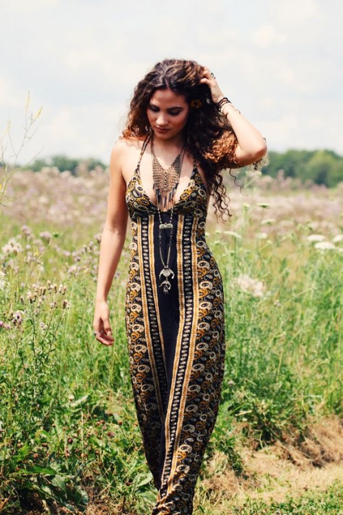 a bold black and gold slip maxi dress with a deep neckline and layered necklaces for a boho or gypsy-inspired look