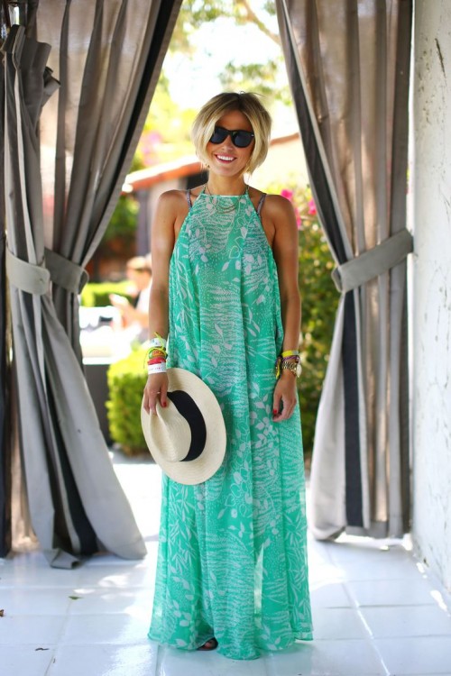 a grene and white printed maxi dress with a halter neckline worn over a swimsuit is a perfect option for a holiday