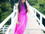 a hot pink halter neckline maxi dress, tan heels and a shiny clutch for a special occasion in summer