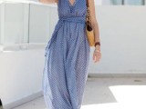 a blue and white polka dot maxi dress with thick straps and a woven bag looks chic and cool