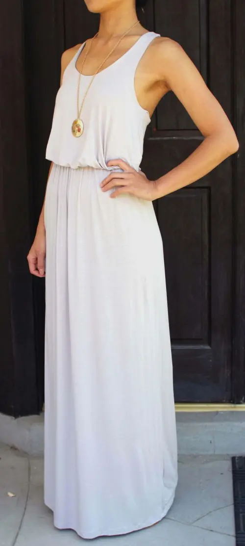 a white maxi dress with thick straps and a scoop neckline plus a statement necklace is a cool idea for every day
