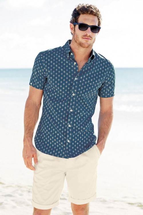 a navy printed short-sleeve shirt and tan shorts are all you need for a relaxed beach holiday