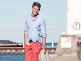 a bleu shirt, coral shorts, tan sneakers and a grey jacket for a relaxed seaside holiday