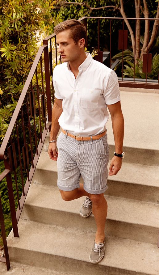 A white short sleeve shirt, striped shorts, grey sneakers for a relaxed and casual holiday