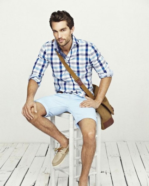 a blue plaid shirt, light blue shorts, tan moccasins and a crossbody bag is a simple and relaxed look