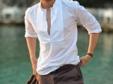 a white long sleeve shirt with a deep cut, brown shorts and tan moccasins for a seaside look
