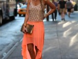 an embellished spaghetti strap top, a coral asymmetric maxi skirt, nude shoes and a metallic clutch