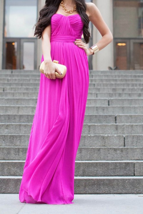 a strapless draped hot pink maxi dress, statement accessories and a metallic clutch