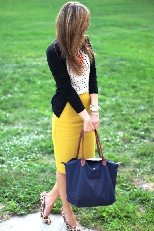 A polka dot top, a black cardigna, a mustard pencil skirt, leopard flats and a navy bag