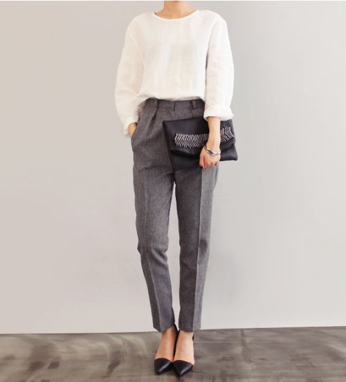 a white long sleeve top, grey pants, a black embellished clutch and blakc plus sheer flats