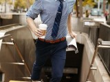 a stylish summer work look with navy cuffed pants, a blue printed shirt, a navy tie and brown shoes