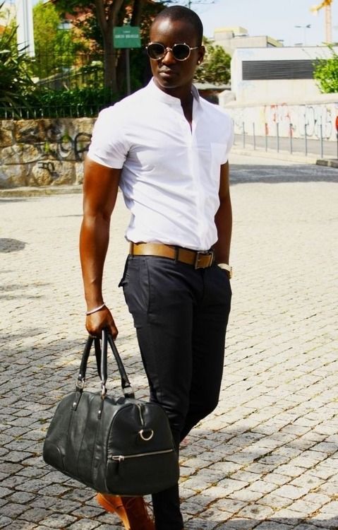 a monochromatic outfit with black pants, a white short-sleeved shirt and a black bag