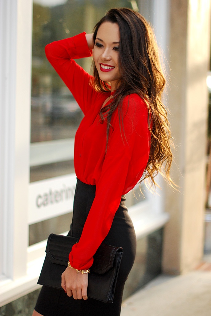 A black pencil skirt, a red blouse, a black clutch   such an outfit will make a statement with its contrasting color scheme