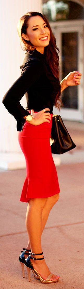 a black blouse, a hot red pencil knee skirt, metallic heels and a black bag make up a bold and contrasting outfit