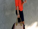 a navy pencil mini, an orange top, grey shoes and a color print bag is a playful and bright outfit