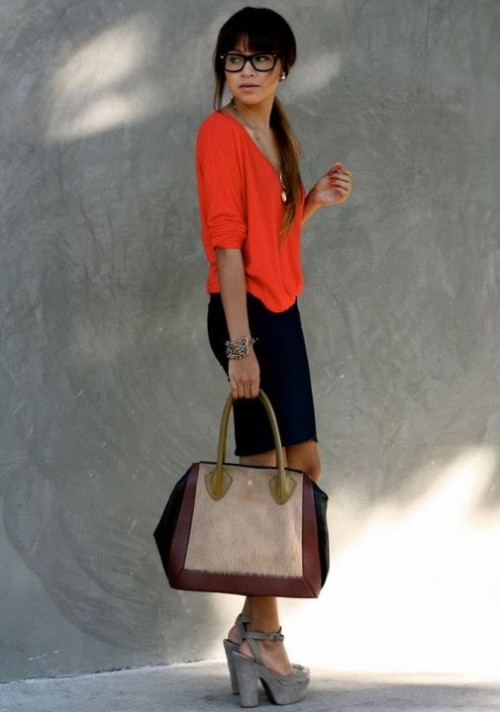 a navy pencil mini, an orange top, grey shoes and a color print bag is a playful and bright outfit